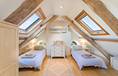 Attic bedroom with two single beds